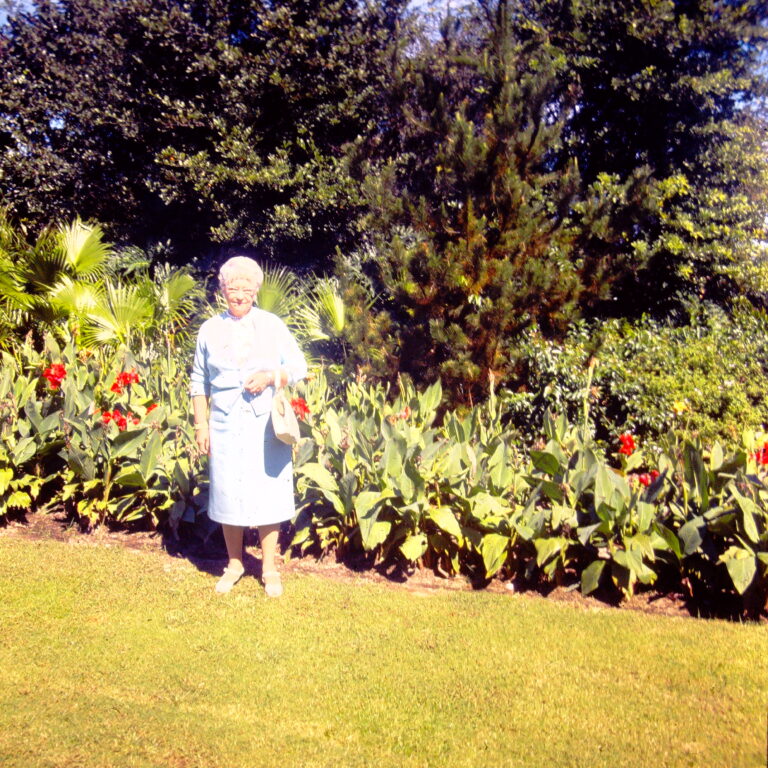 Llewellyn Thorward-Moore standing in front of flowers.